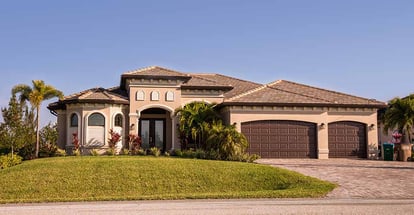 Concrete block and stucco home in the countryside with palm trees in Florida