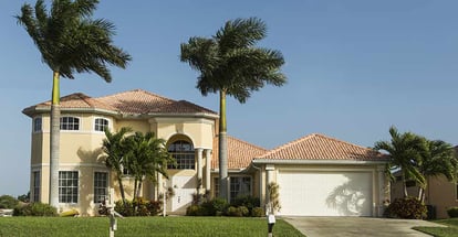 Concrete block and stucco home in the countryside with tropical plants in Florida