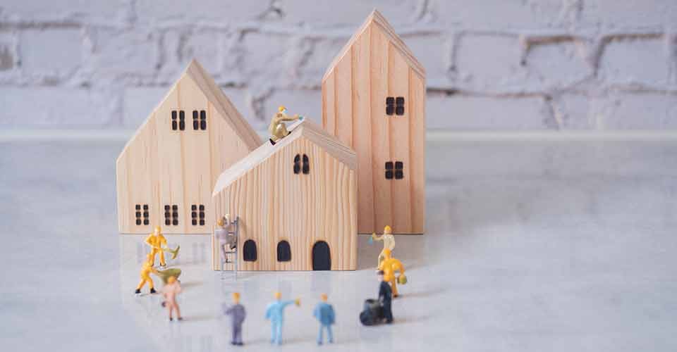 Construction miniature workers team working on house renovation