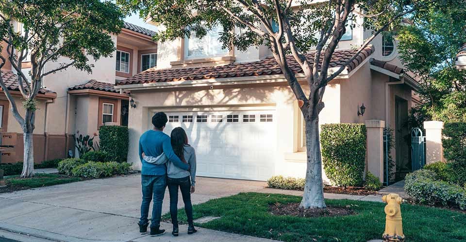 Couple Standing In Front of their House in florida
