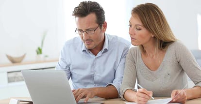 Couple at home working on laptop computer