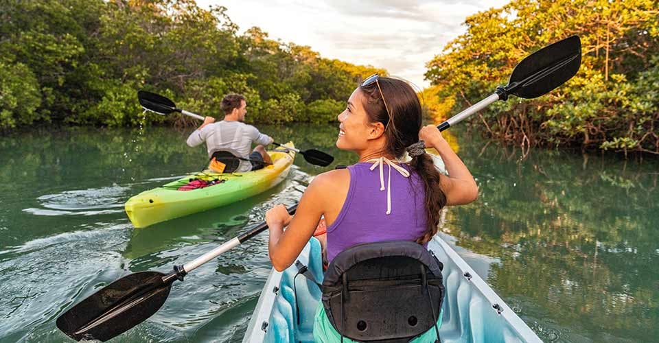 Couple kayaking together in mangrove river of the Keys Florida