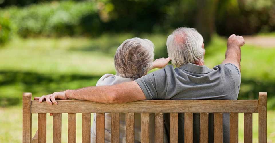 Couple sitting on the bench with their back to the camera