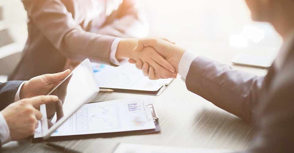 Customer and realtor shaking hands after home purchase agreement