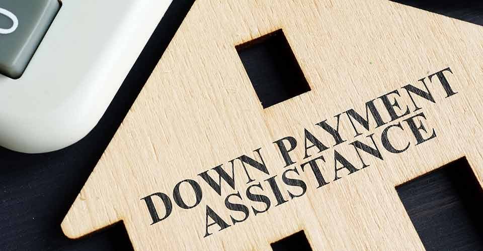 Down payment assistance written on house model