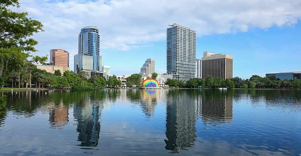 Downtown Orlando skyline glistens as it reflects in the clean waters of Lake Eola in Florida