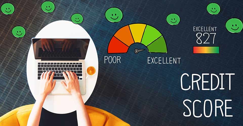 Excellent Credit Score and person using a laptop on a white table