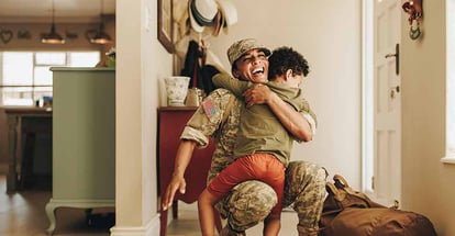 Excited military mom embracing her son after returning home