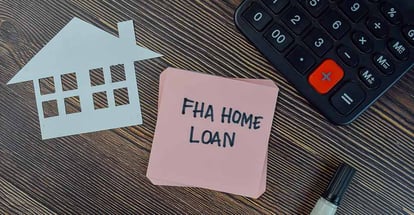 FHA Home Loan written on sticky notes on Wooden Table