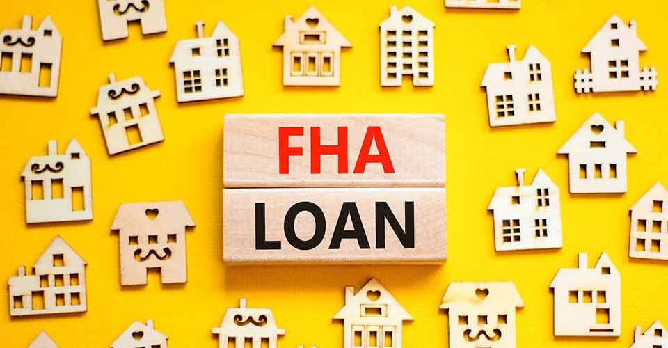 FHA Loan words on wooden blocks and toy house
