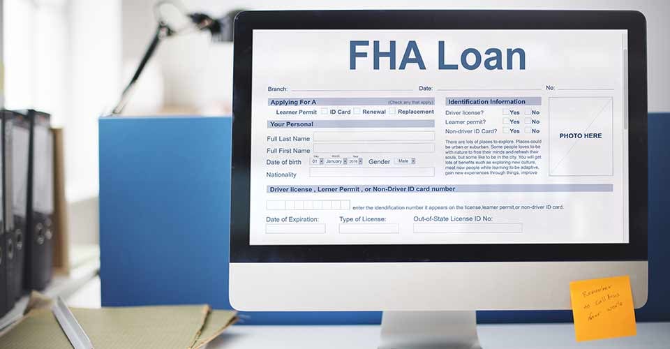FHA loan form and documents on a computer