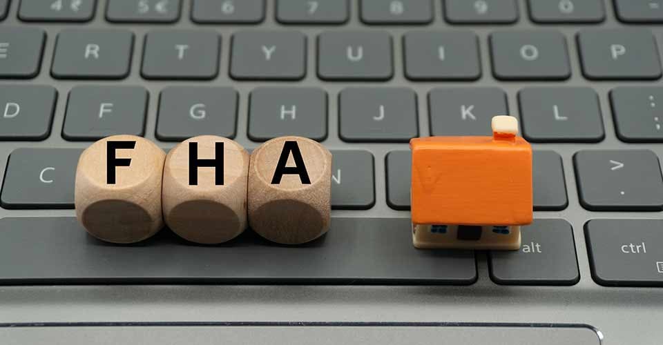 FHA loan word written on dice and modal house