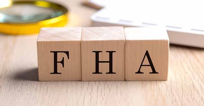 FHA text on a wooden cubes with magnifier and calculator