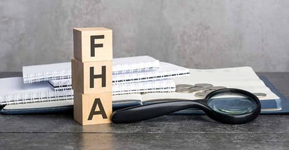 FHA word written on wooden cubes and paper documents