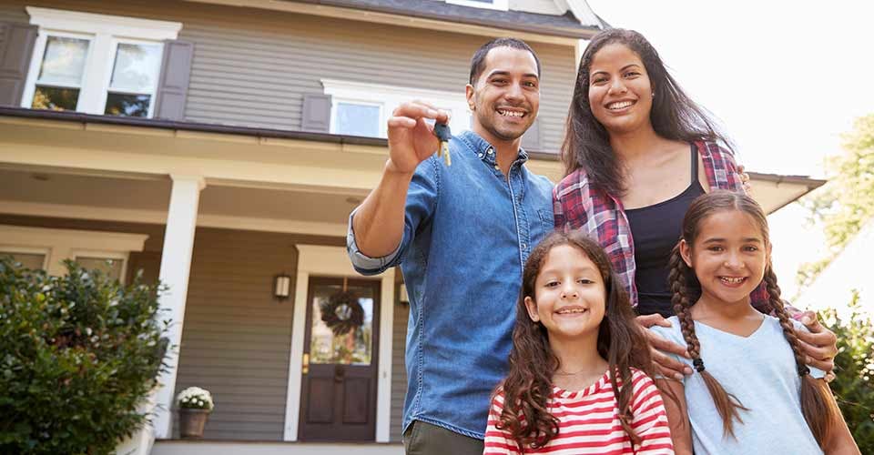 Family Holding Keys to New Home on Moving Day