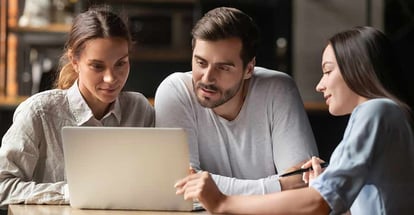 Female financial advisor consult young couple showing document on laptop in office