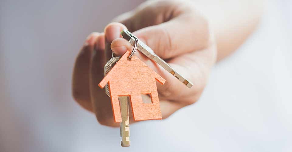 Female hand holding house key