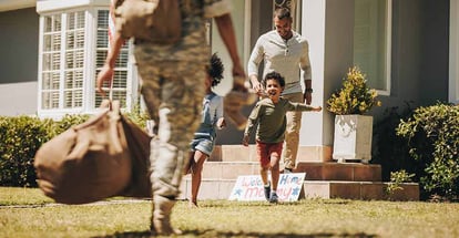Female soldier receiving a warm welcome from her husband and kids