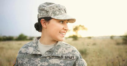 Female soldier smiles in the desert