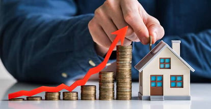 Graph of coin stack for real estate market and model house with red arrow