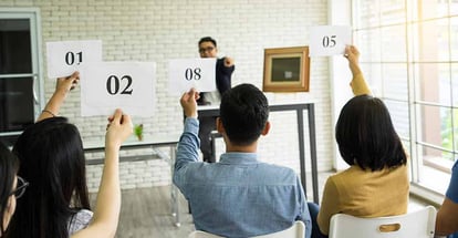 Group of people bidding on a house