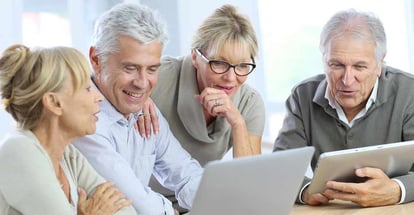 Group of retired senior people using laptop and tablet