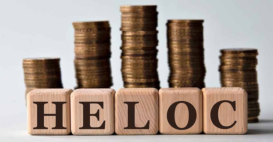 HELOC acronym on wooden cubes and coin stack