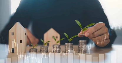 Hand hold coins and planning to buy investment property