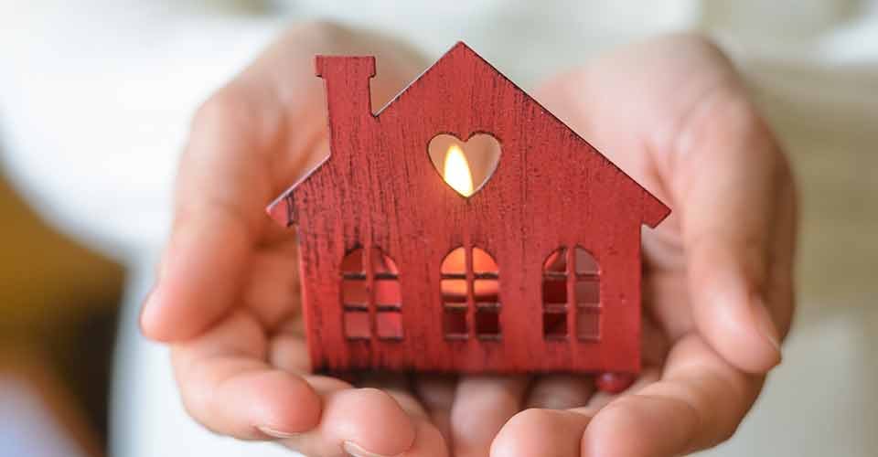 Hand holding a toy house