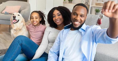 Happy African American family showing keys of their new apartment house