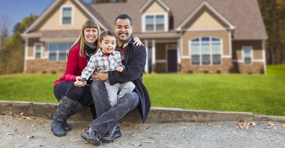 Happy Mixed Race Family in Front of Their Beautiful New Home