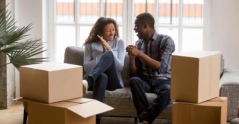 Happy african american couple feeling excited on moving day