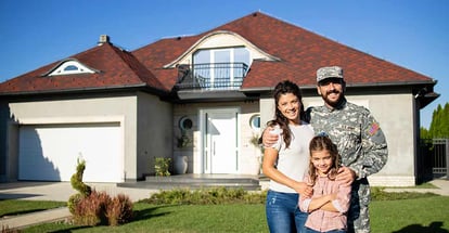 Happy american military family in front of their new house