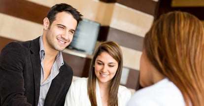 Happy couple talking to a financial adviser