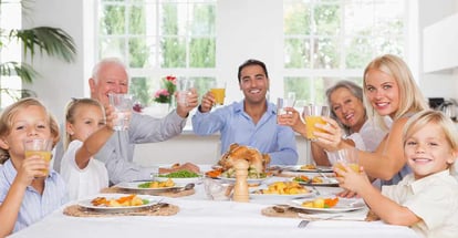 Happy family toasting around the table at thanksgiving dinner