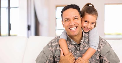 Happy little daughter and military father at new home