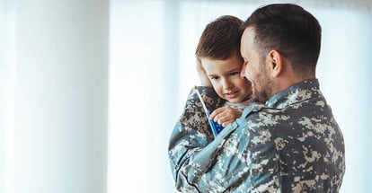 Happy military man with his son at home