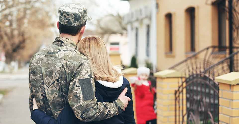 Happy reunion of soldier with family outside their home