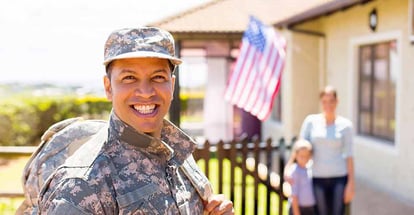 Happy soldier outside his home with family