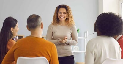 Happy woman talking to group of people