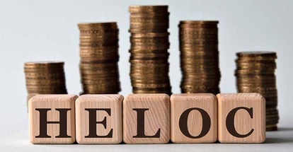 Home equity line of credit acronym on wooden cubes and stacks of coins