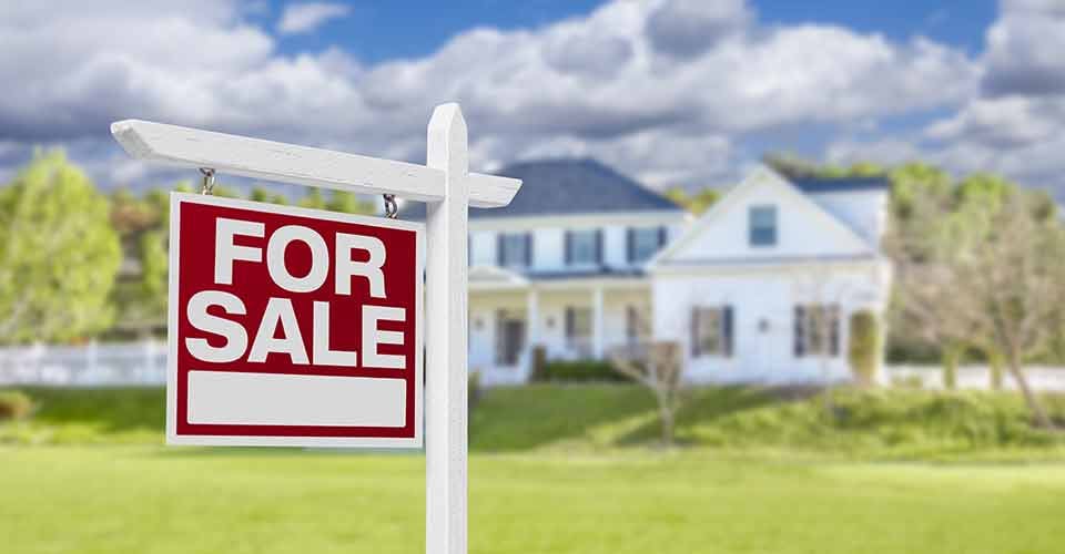 Home for Sale real estate sign in front of beautiful house