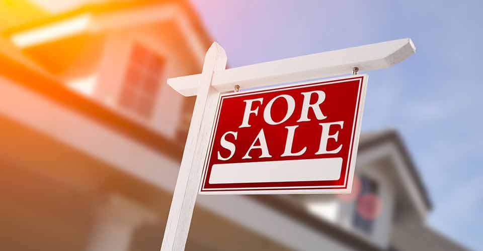 Home for sale sign in front of new house