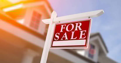 Home for sale sign in front of new house