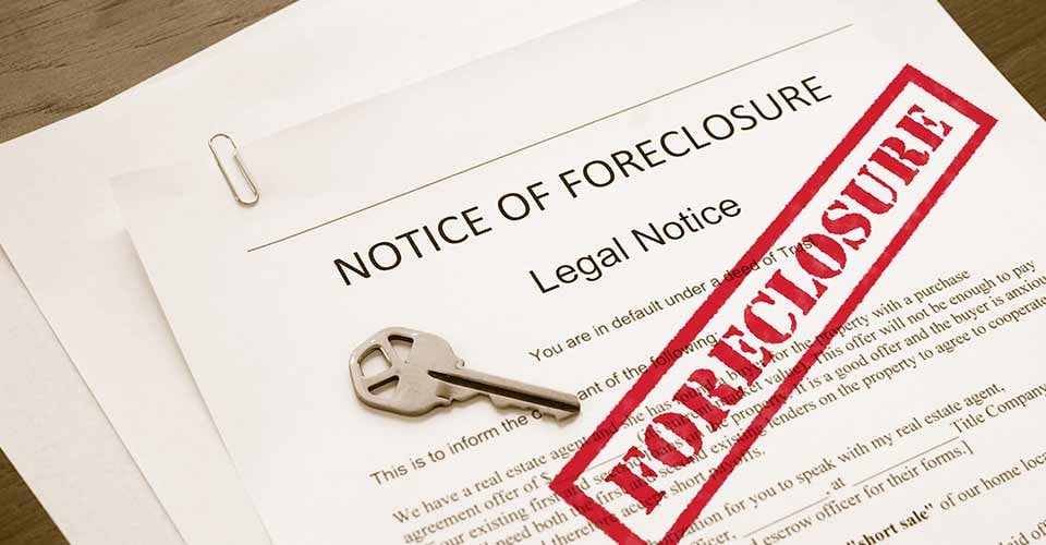 Home foreclosure legal document with house key