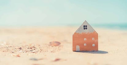 Home model on sand beach