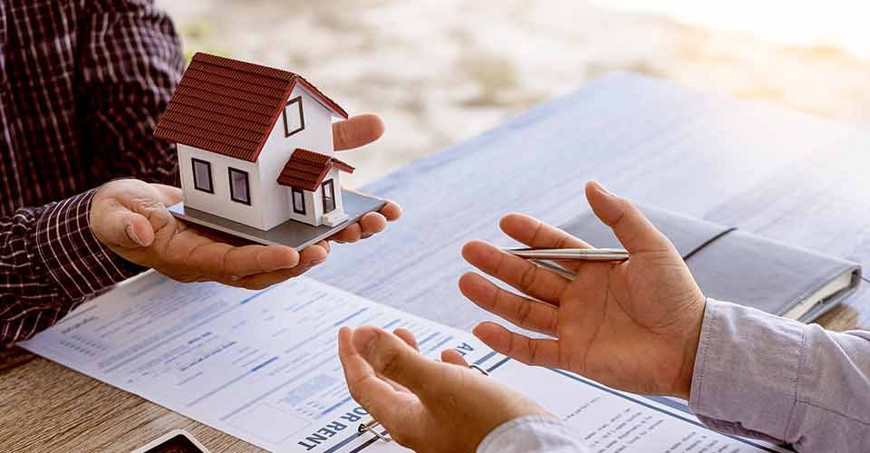 Home sales agents sit at the office with new homebuyers