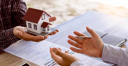 Home sales agents sit at the office with new homebuyers