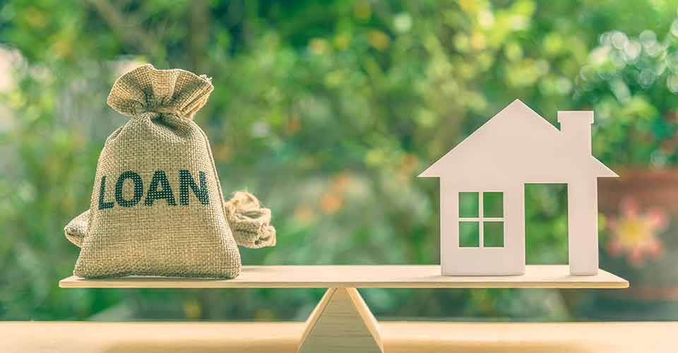 House model and loan bag on scale