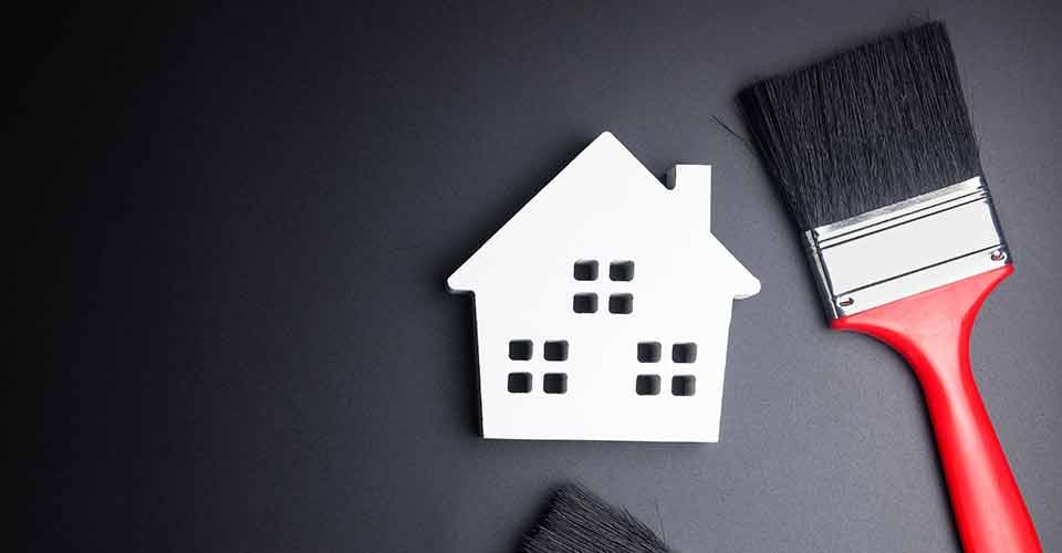 House model and paint brush for home renovation